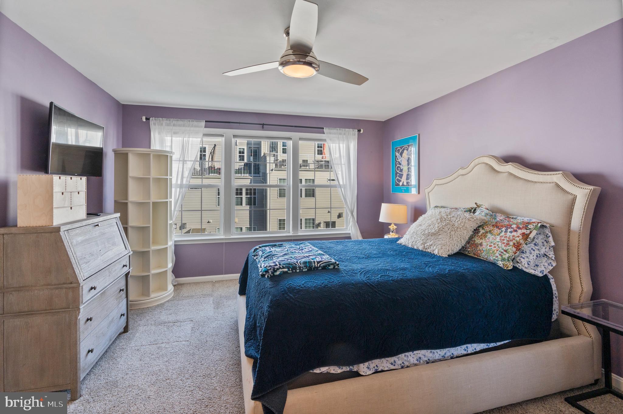 1311 Belt Street Baltimore, MD 21230 - Photo 26 of 65 a bedroom with a large bed and a chandelier