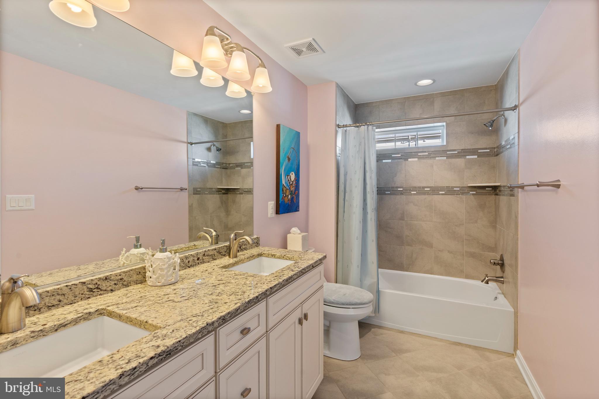 1311 Belt Street Baltimore, MD 21230 - Photo 29 of 65 a bathroom with a granite countertop sink toilet and shower