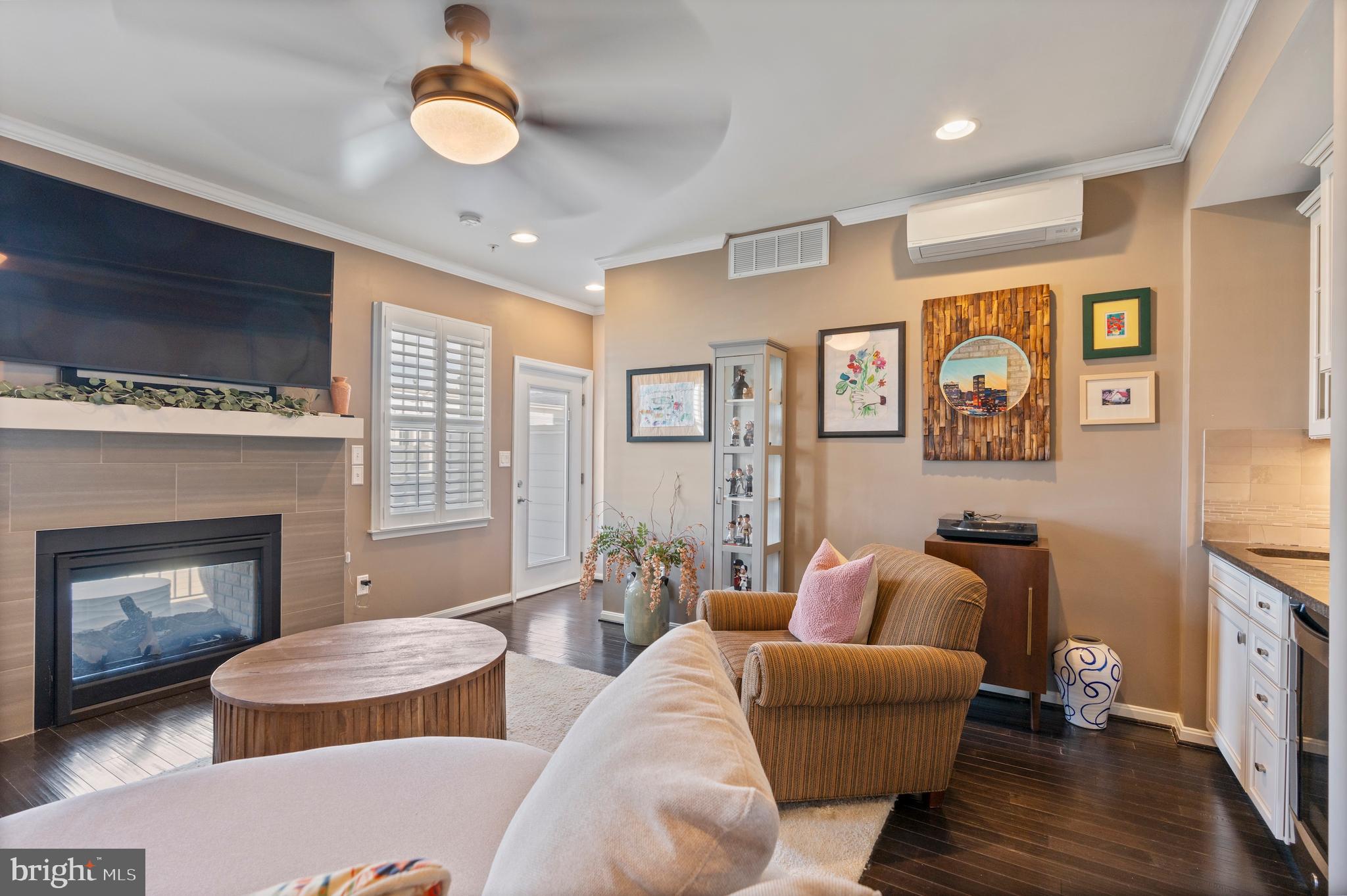 1311 Belt Street Baltimore, MD 21230 - Photo 40 of 65 a living room with furniture a fireplace and wooden floor