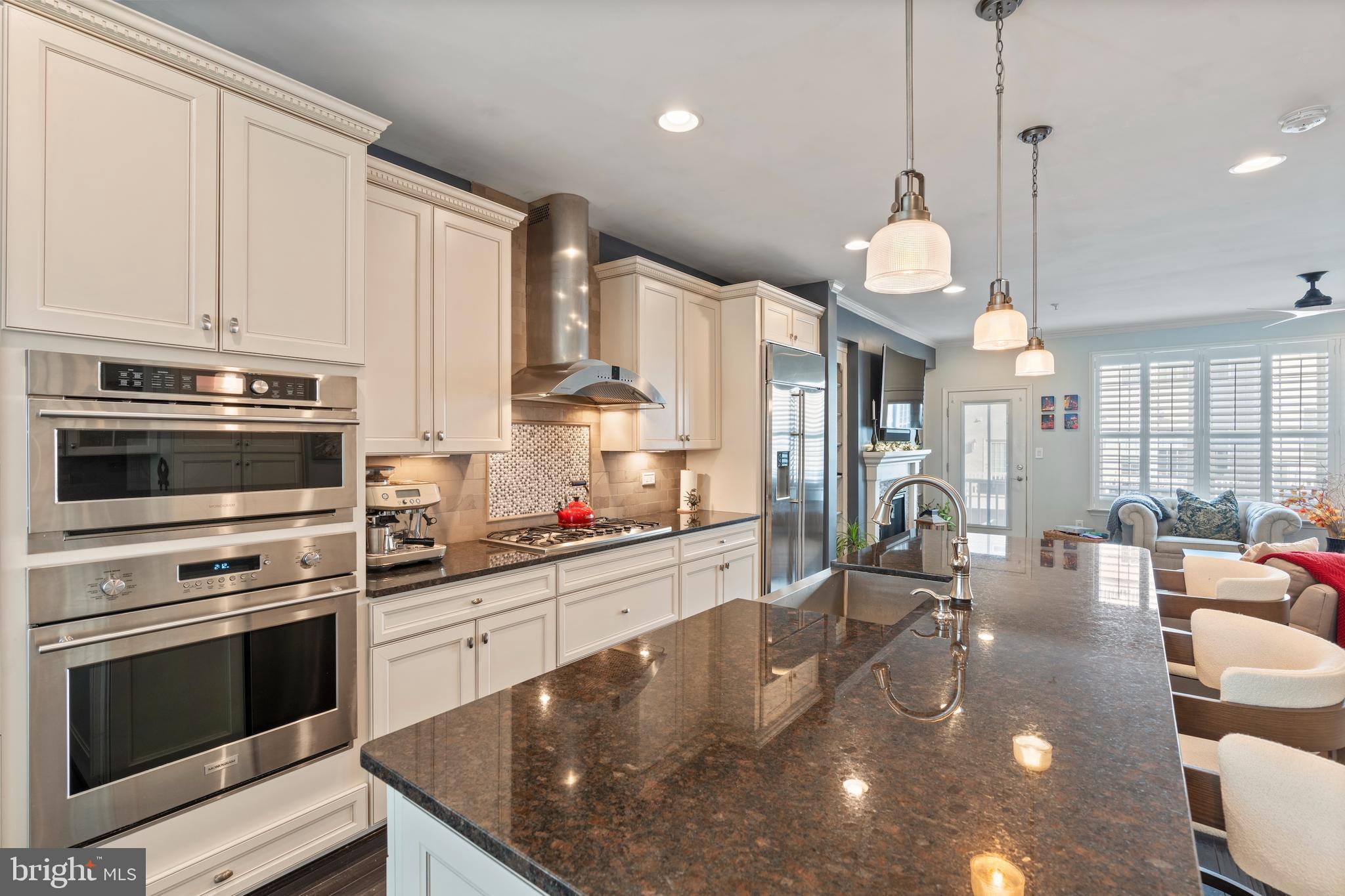 1311 Belt Street Baltimore, MD 21230 - Photo 6 of 65 a kitchen with stainless steel appliances granite countertop a sink a stove and a wooden floors