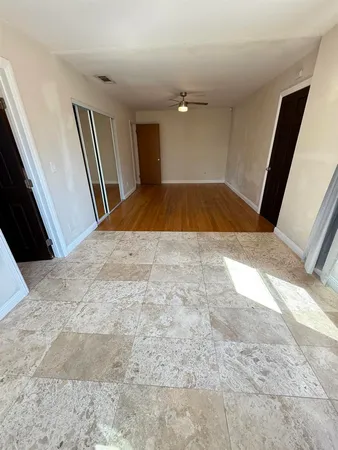 a view of a livingroom with wooden floor and staircase