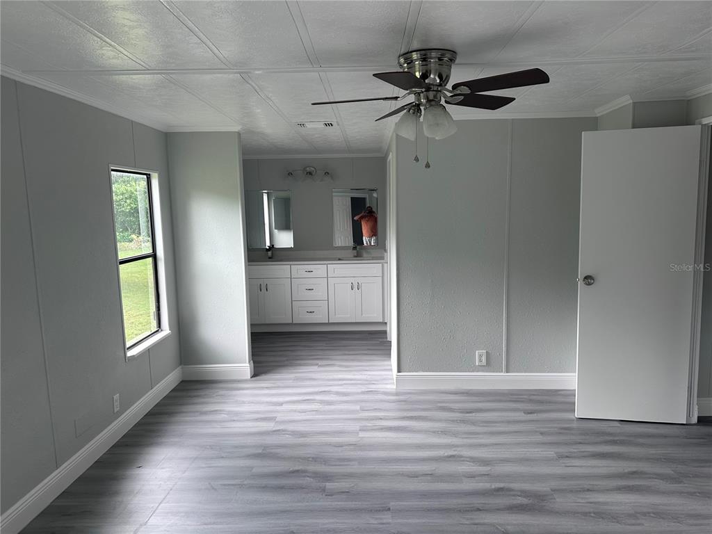 3458 North Citrus Circle, Unit 1803 Zellwood, FL 32798 - Photo 14 of 20 a view of empty room with wooden floor and window