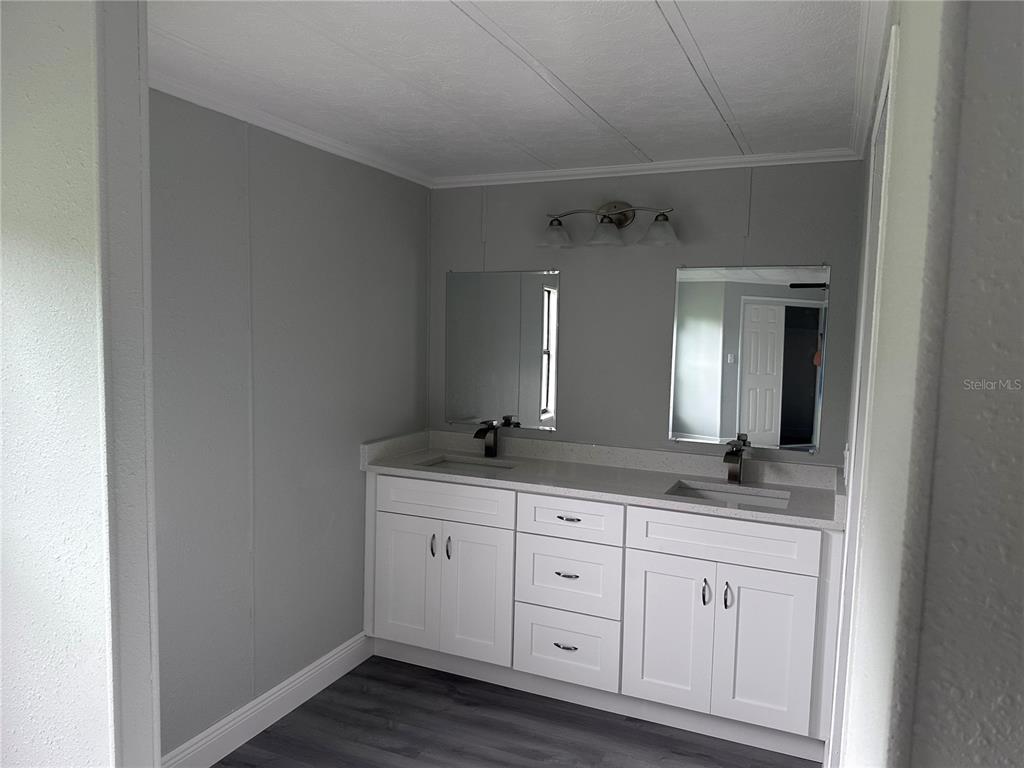 3458 North Citrus Circle, Unit 1803 Zellwood, FL 32798 - Photo 16 of 20 a bathroom with a granite countertop sink and a mirror