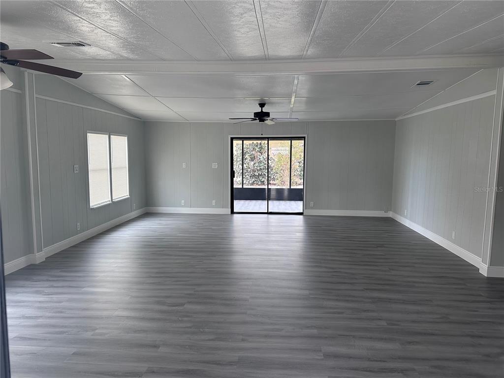 3458 North Citrus Circle, Unit 1803 Zellwood, FL 32798 - Photo 4 of 20 an empty room with wooden floor and windows