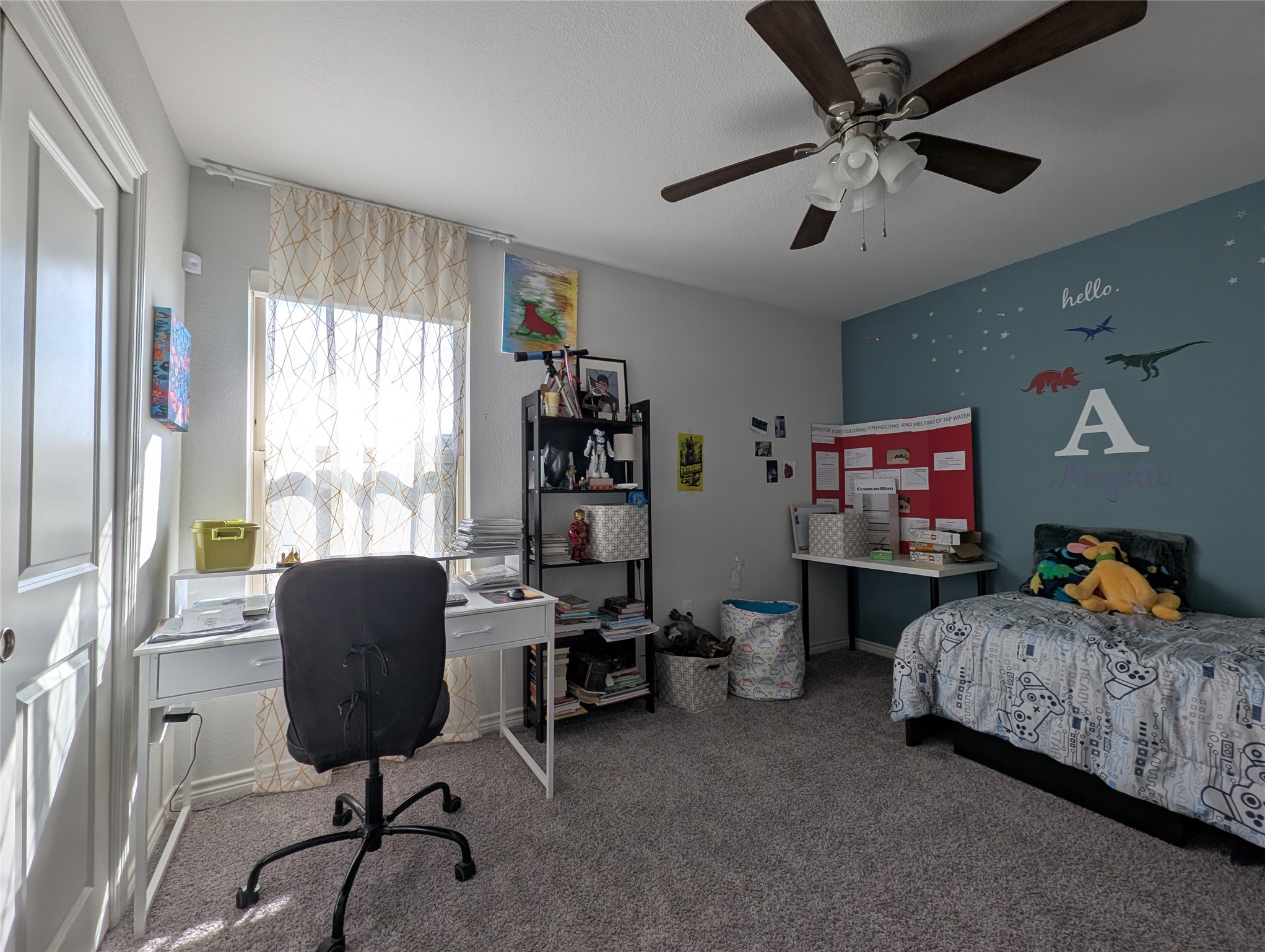 14502 McCoy Loop Austin, TX 78717 - Photo 15 of 26 Carpeted room featuring a ceiling fan with integrated lighting, a window with sheer curtains, and a two-panel interior door
