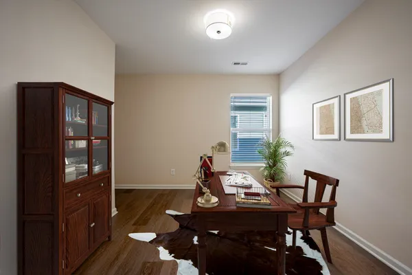 a view of an empty room with wooden floor