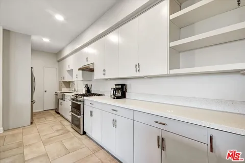 a kitchen with cabinets and appliances