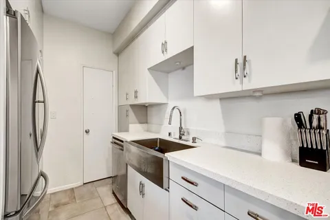 a kitchen with stainless steel appliances a sink stove and refrigerator