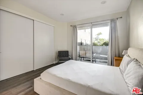 a bedroom with a large bed and a large window