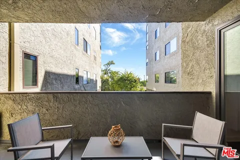 a view of a chair and table in the balcony