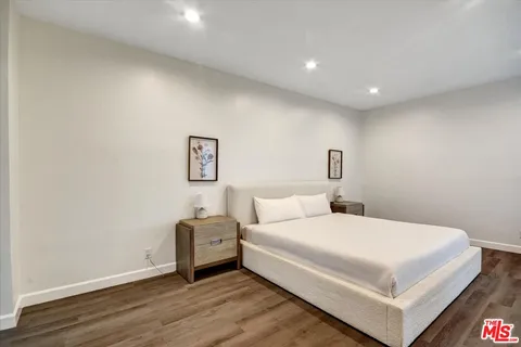 a bedroom with a bed and a night stand