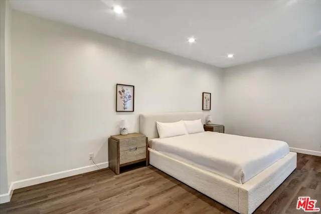 a bedroom with a bed and a night stand