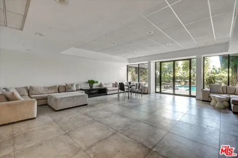 a living room with furniture and a floor to ceiling window