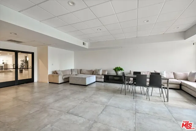 a living room with furniture and dining table