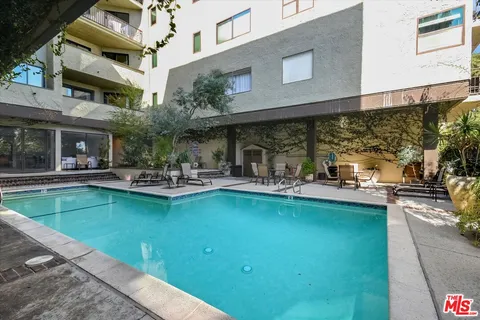 a view of a swimming pool with outdoor seating