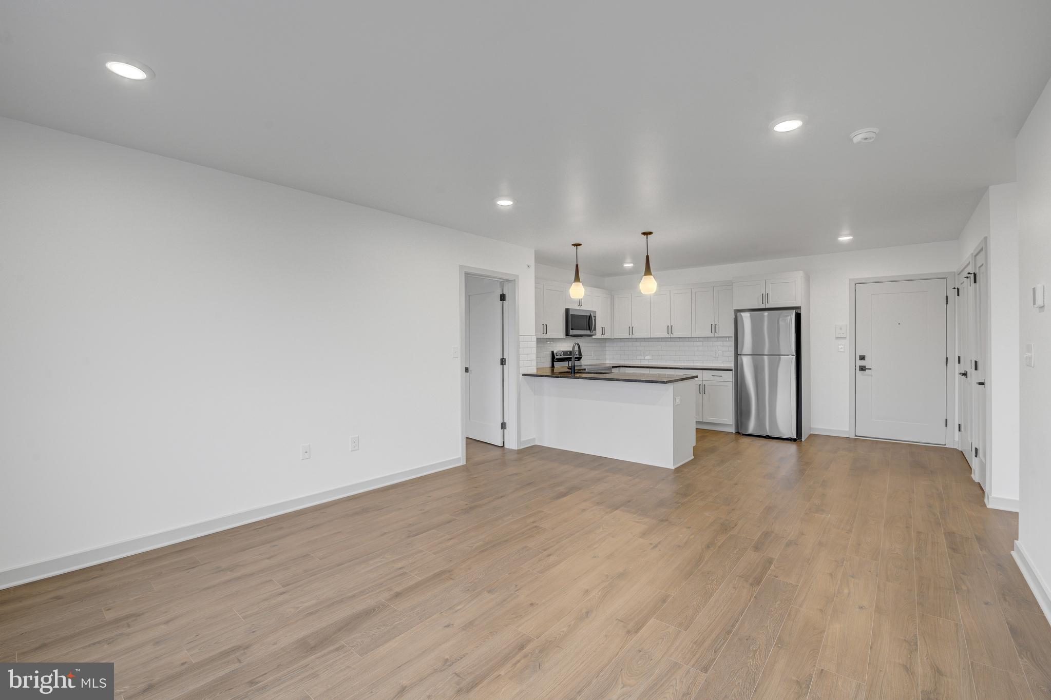 6808 Ridge Avenue, Unit 418 Philadelphia, PA 19128 - Photo 6 of 10 a view of a kitchen with a sink and a refrigerator