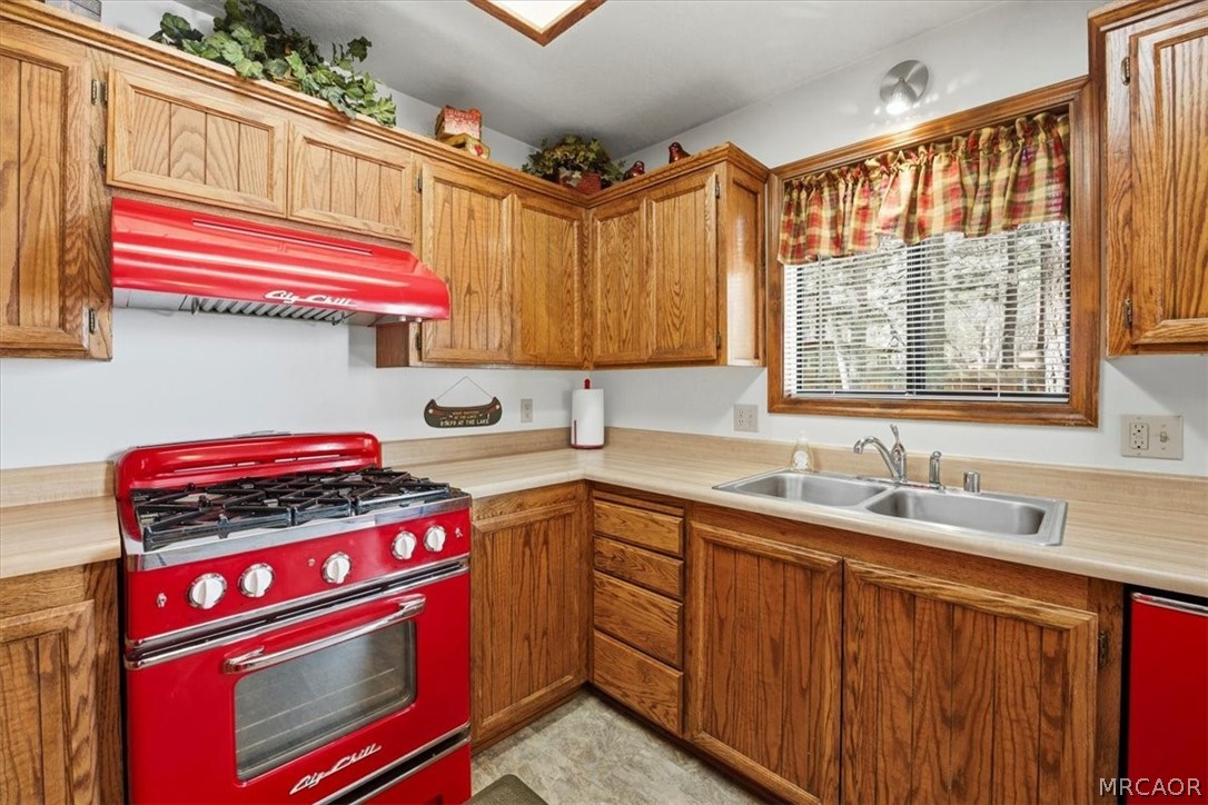 358 Victoria Lane Sugarloaf, CA 92386 - Photo 17 of 38 a kitchen with a stove a sink and a window