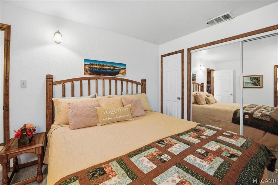 358 Victoria Lane Sugarloaf, CA 92386 - Photo 20 of 38 a bedroom with a bed and a mirror