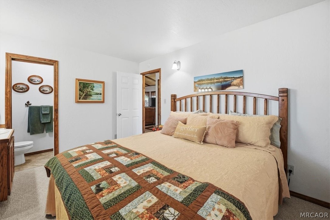 358 Victoria Lane Sugarloaf, CA 92386 - Photo 21 of 38 a large bed sitting in a bedroom next to a window