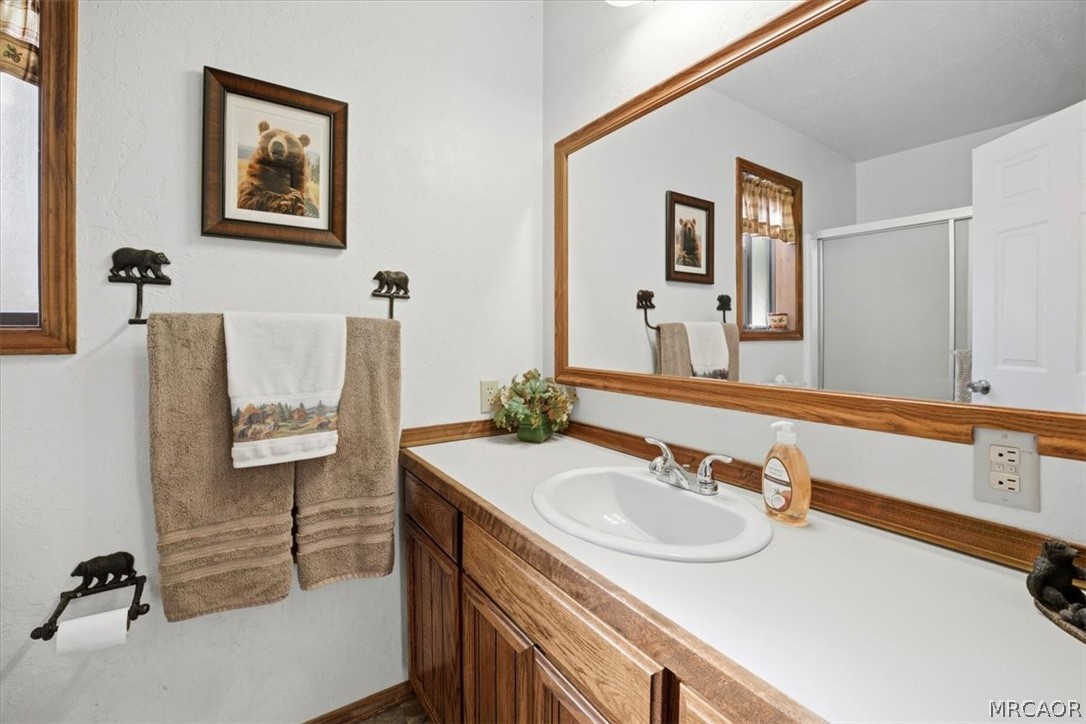 358 Victoria Lane Sugarloaf, CA 92386 - Photo 26 of 38 a bathroom with a sink and a mirror
