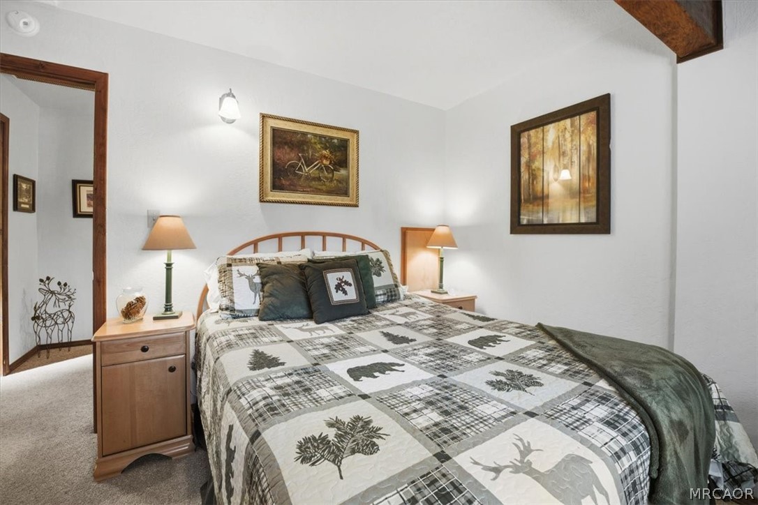 358 Victoria Lane Sugarloaf, CA 92386 - Photo 29 of 38 a bedroom with a bed and a painting on the wall