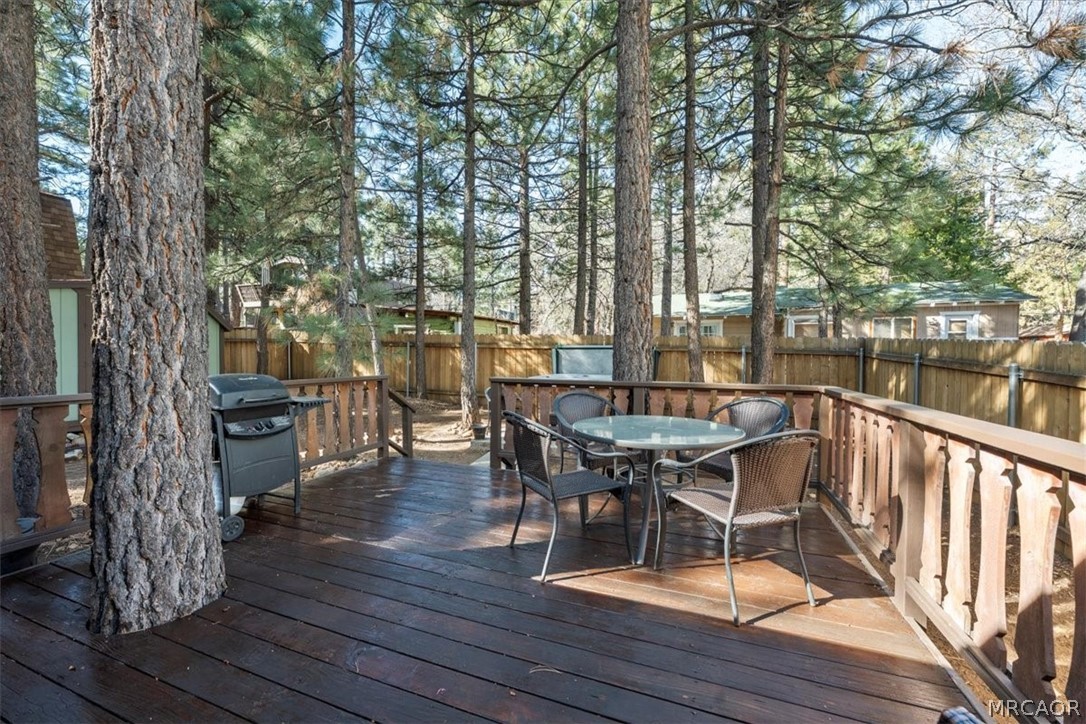 358 Victoria Lane Sugarloaf, CA 92386 - Photo 31 of 38 a view of a deck with table and chairs and wooden floor