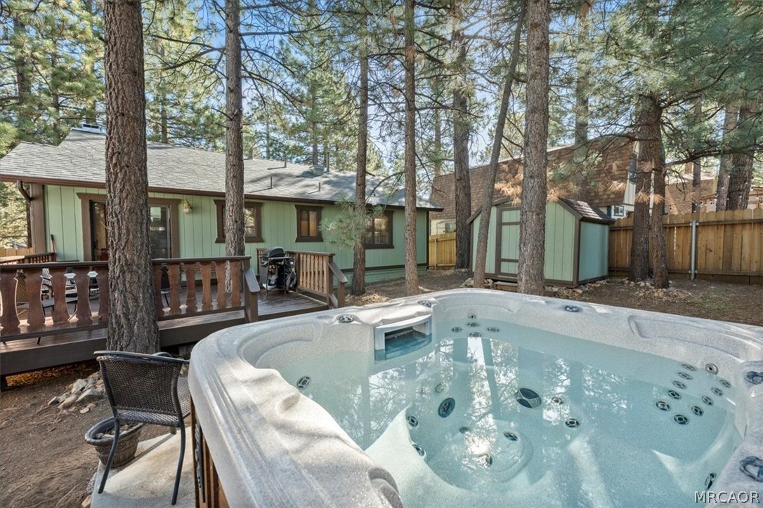 358 Victoria Lane Sugarloaf, CA 92386 - Photo 34 of 38 a view of a patio with couches table and chairs with wooden fence and large trees
