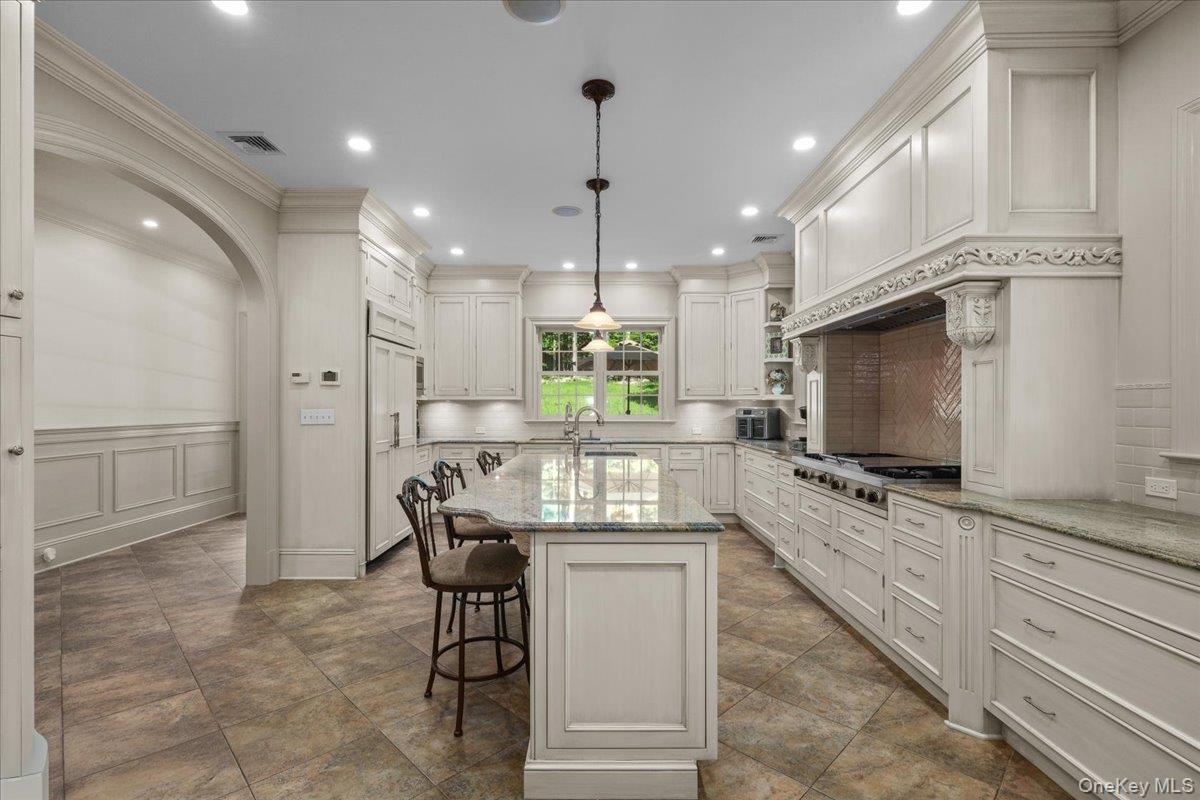 135 Pines Bridge Road Katonah, NY 10536 - Photo 4 of 40 a kitchen with stainless steel appliances kitchen island granite countertop a stove and a sink