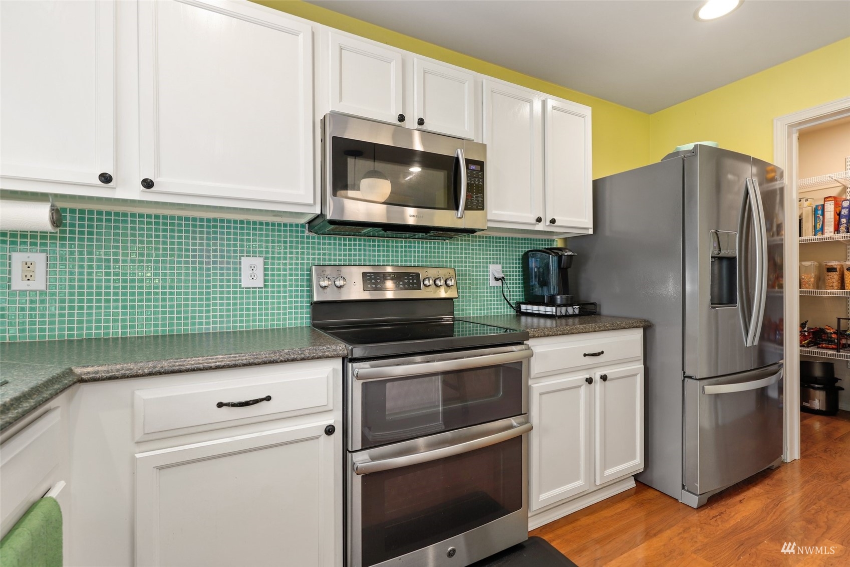 18808 1st Place West Bothell, WA 98012 - Photo 11 of 40 a kitchen with stainless steel appliances granite countertop a refrigerator stove and microwave