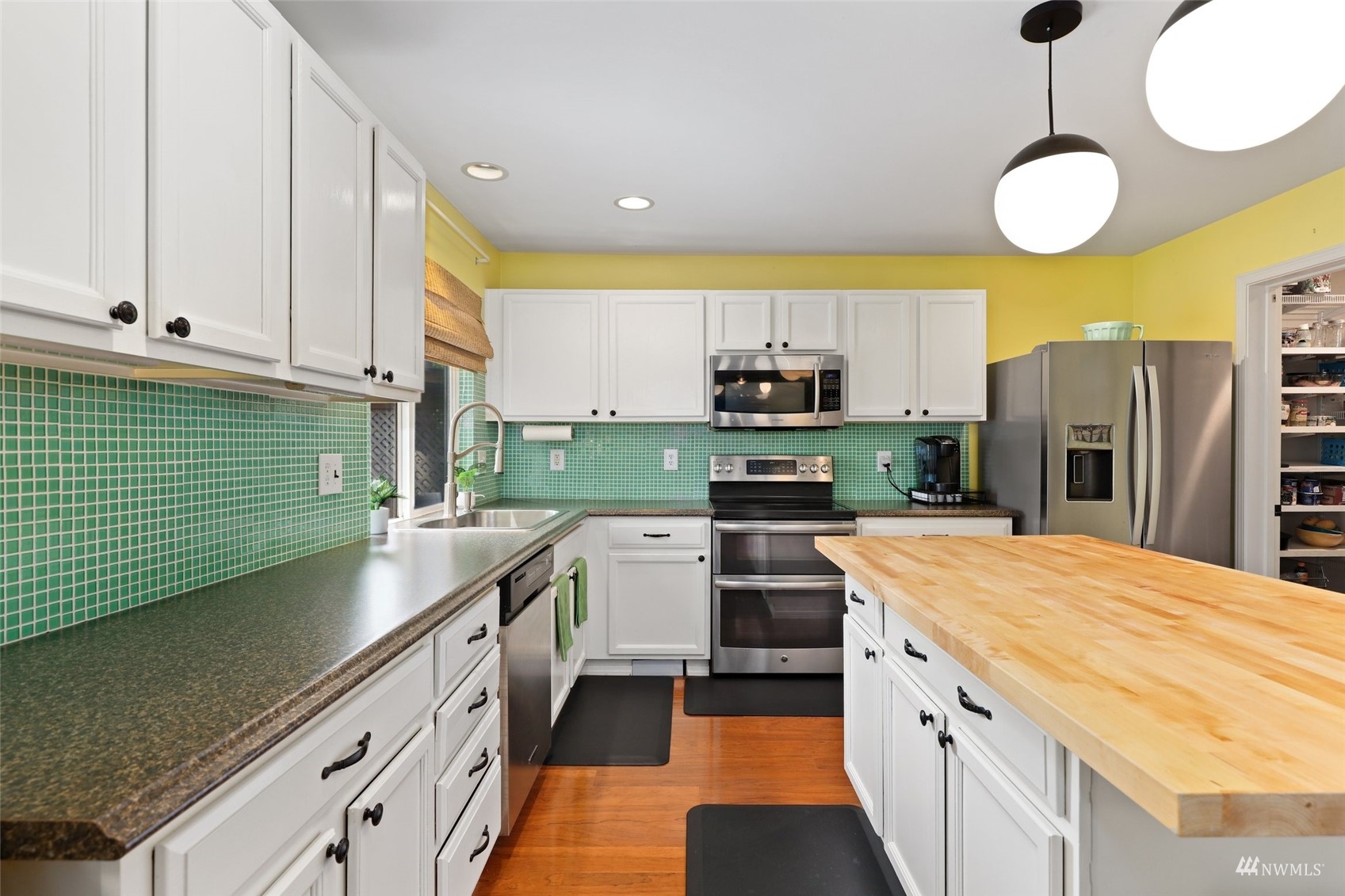18808 1st Place West Bothell, WA 98012 - Photo 12 of 40 a kitchen with stainless steel appliances granite countertop a sink a stove and a refrigerator