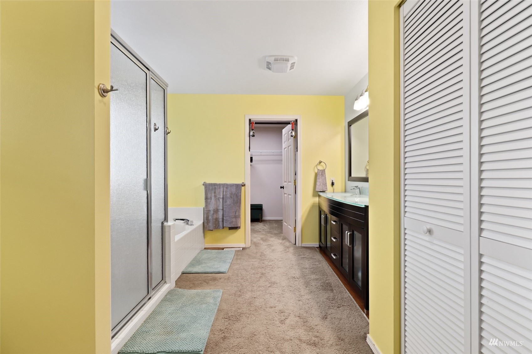 18808 1st Place West Bothell, WA 98012 - Photo 22 of 40 a bathroom with a sink a mirror and a shower