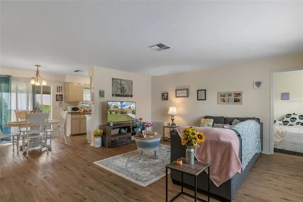 a bedroom with furniture and a wooden floor