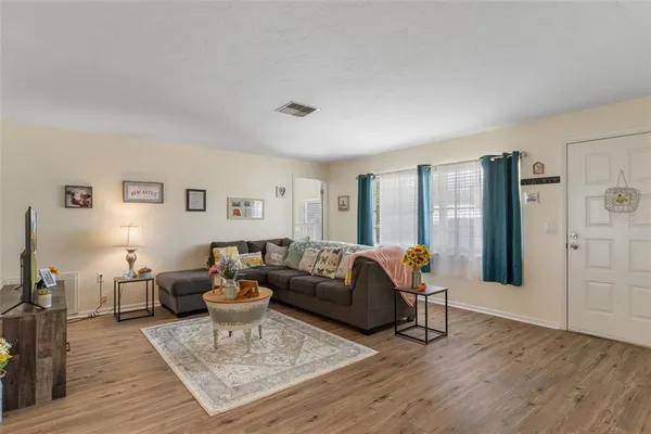 a living room with furniture and wooden floor