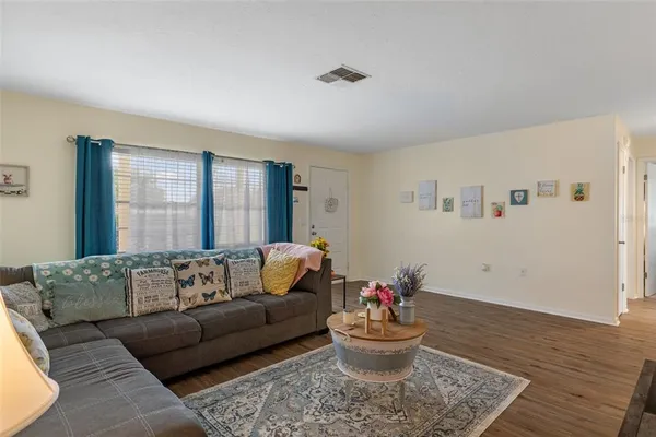 a living room with furniture and flowers