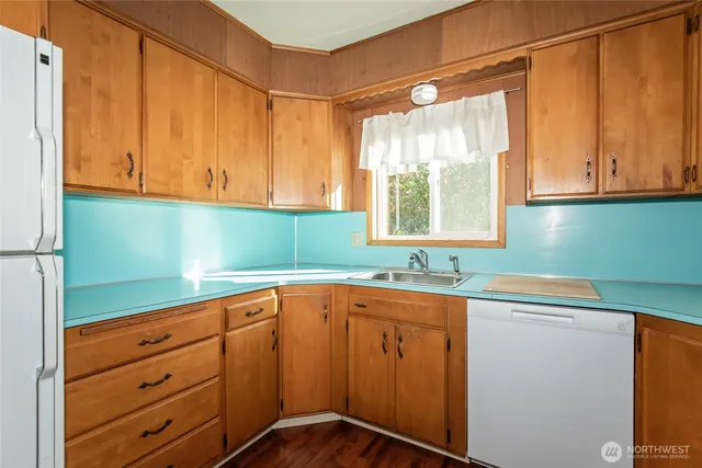 a kitchen with stainless steel appliances granite countertop a sink and cabinets