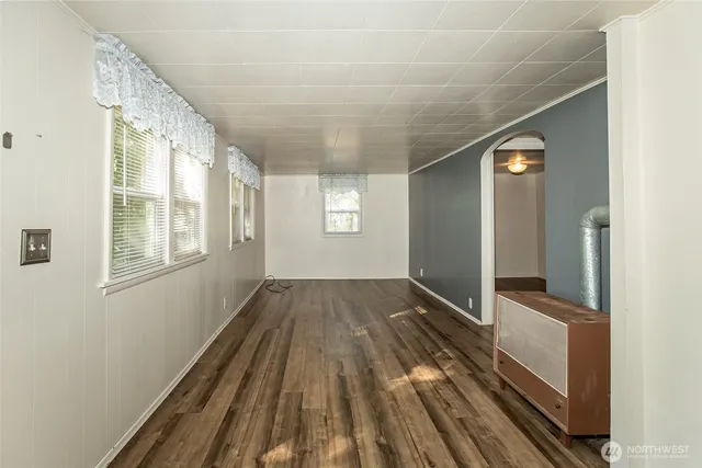 a view of a room with wooden floor and window