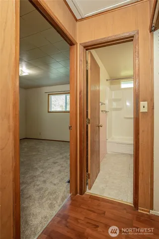a bathroom with a sink double vanity mirror and a bathtub