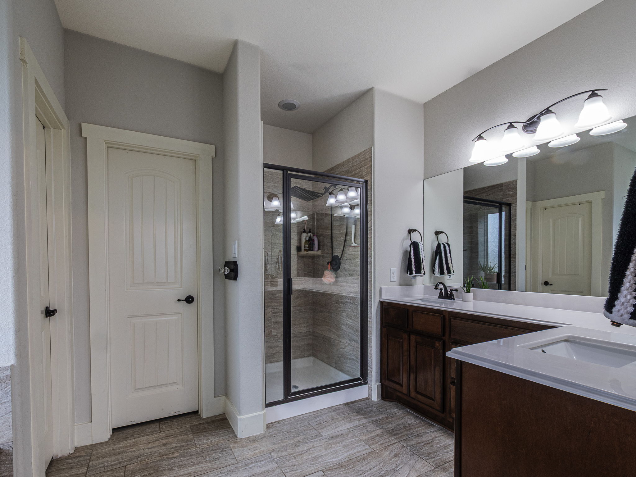 117 Arbor Point Drive Elgin, TX 78621 - Photo 16 of 40 a bathroom with a double vanity sink and a mirror