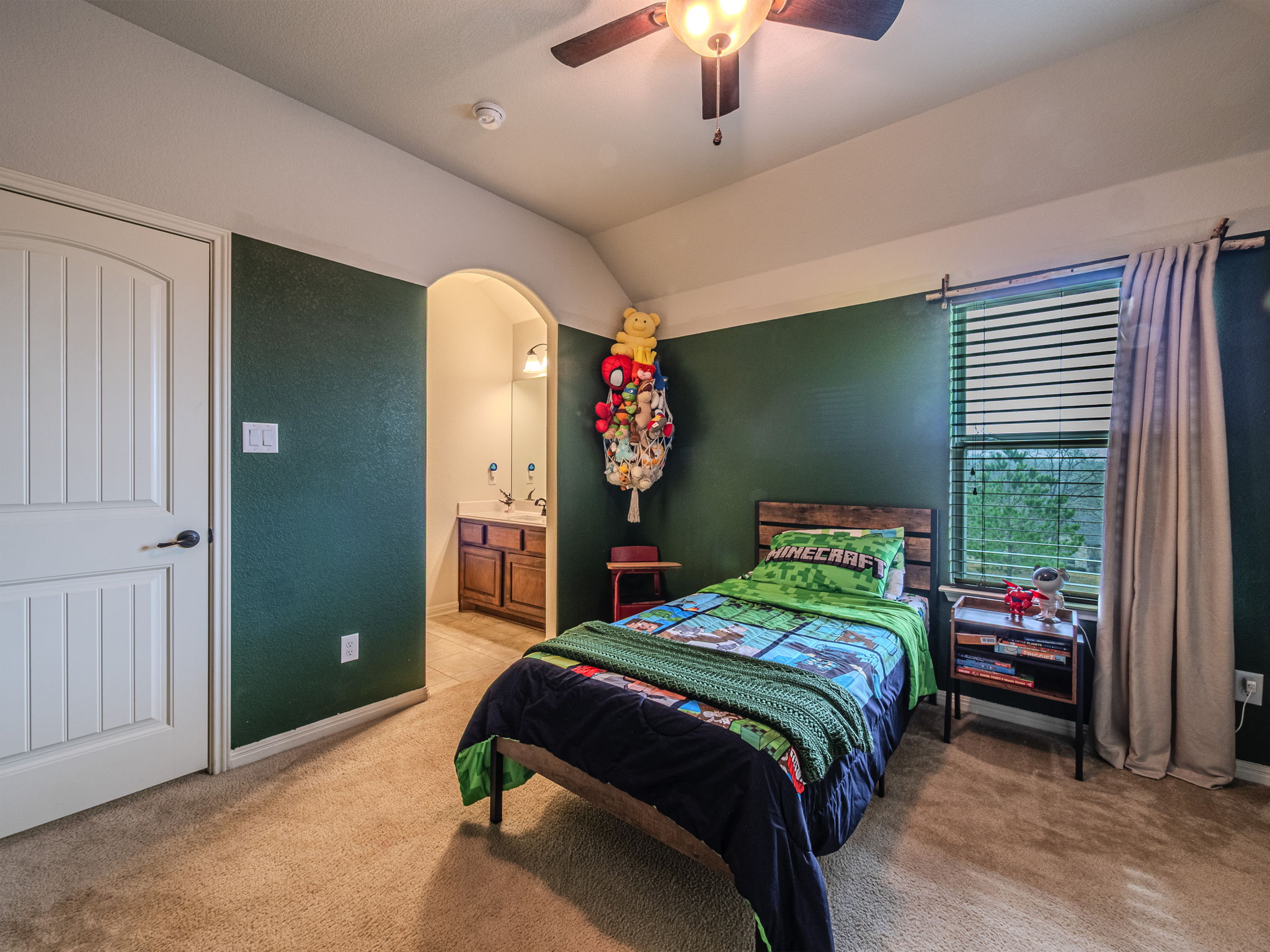 117 Arbor Point Drive Elgin, TX 78621 - Photo 27 of 40 a bedroom with a bed and a chandelier