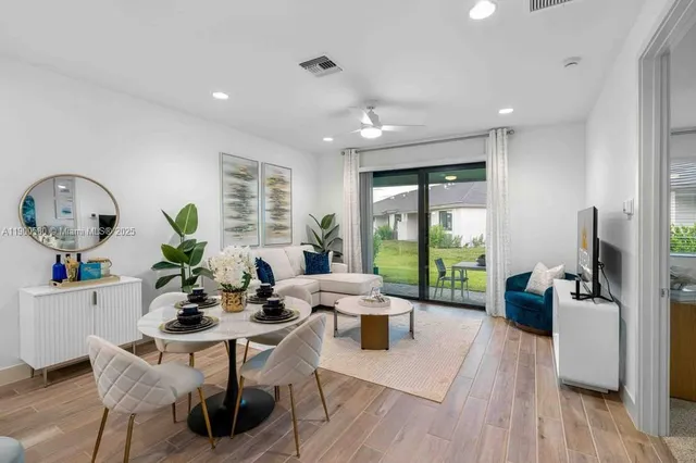 a bathroom with a sink a potted plant and a mirror