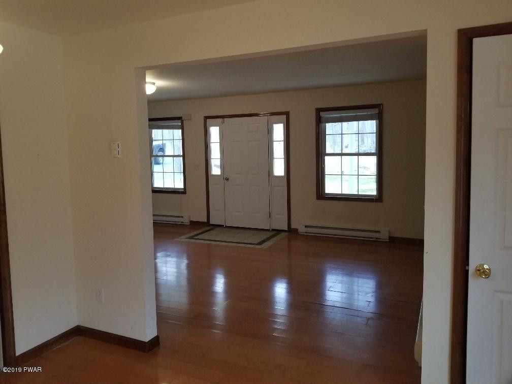 116 Walnut Road Milford, PA 18337 - Photo 12 of 22 an empty room with wooden floor and windows