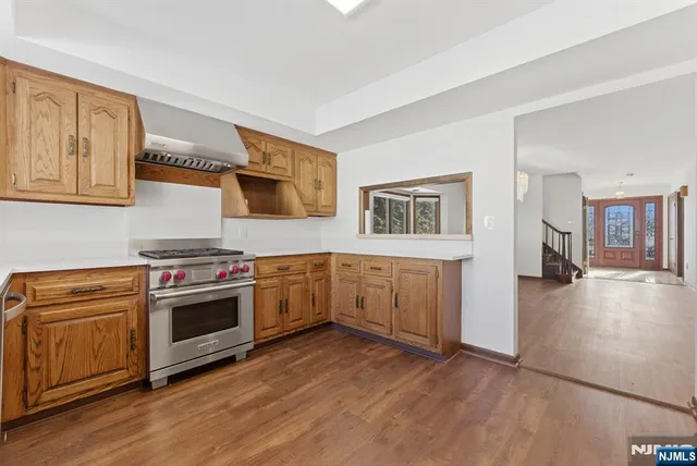 a kitchen with stainless steel appliances granite countertop a stove and a sink