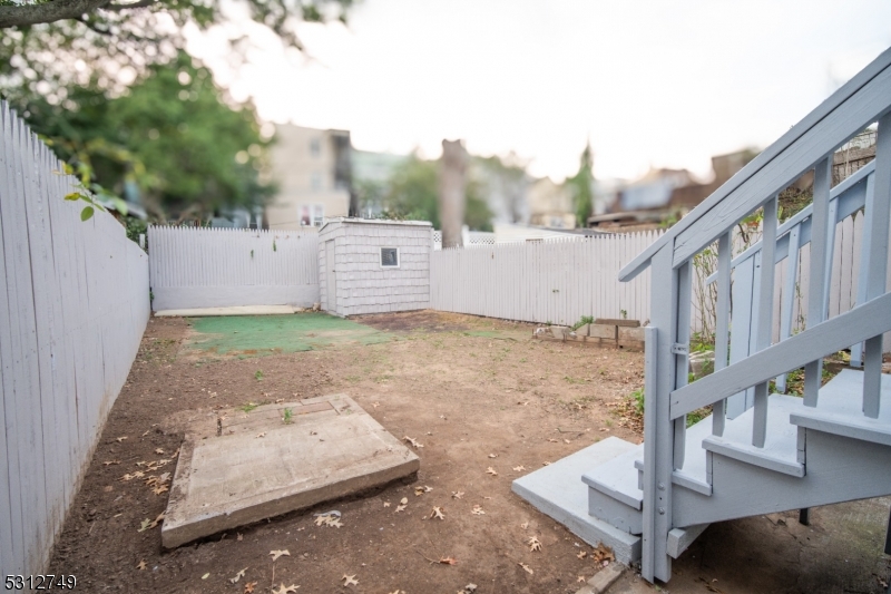 124 Stone Street, Unit 2 Newark, NJ 07104 - Photo 12 of 27 a view of a small house with wooden fence