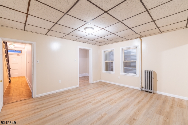 124 Stone Street, Unit 2 Newark, NJ 07104 - Photo 14 of 27 a view of empty room with wooden floor and fan