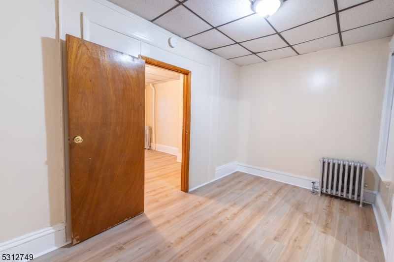 124 Stone Street, Unit 2 Newark, NJ 07104 - Photo 16 of 27 a view of a hallway with wooden floor