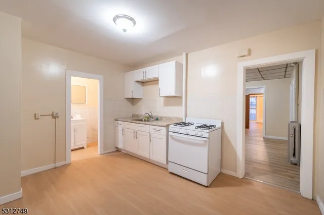 a kitchen with stainless steel appliances granite countertop a stove and a refrigerator
