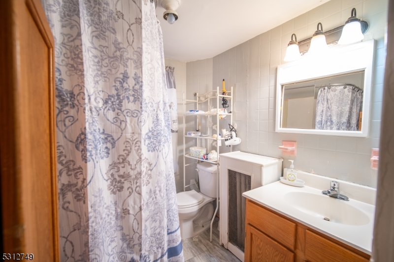 124 Stone Street, Unit 2 Newark, NJ 07104 - Photo 19 of 27 a bathroom with a sink toilet tub and shower