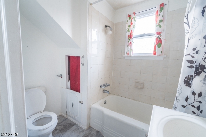 124 Stone Street, Unit 2 Newark, NJ 07104 - Photo 22 of 27 a bathroom with a bathtub toilet and sink