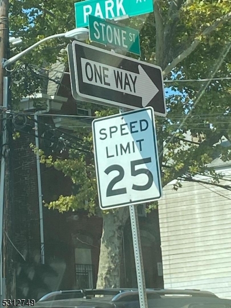 124 Stone Street, Unit 2 Newark, NJ 07104 - Photo 4 of 27 a sign broad on the side of the tree