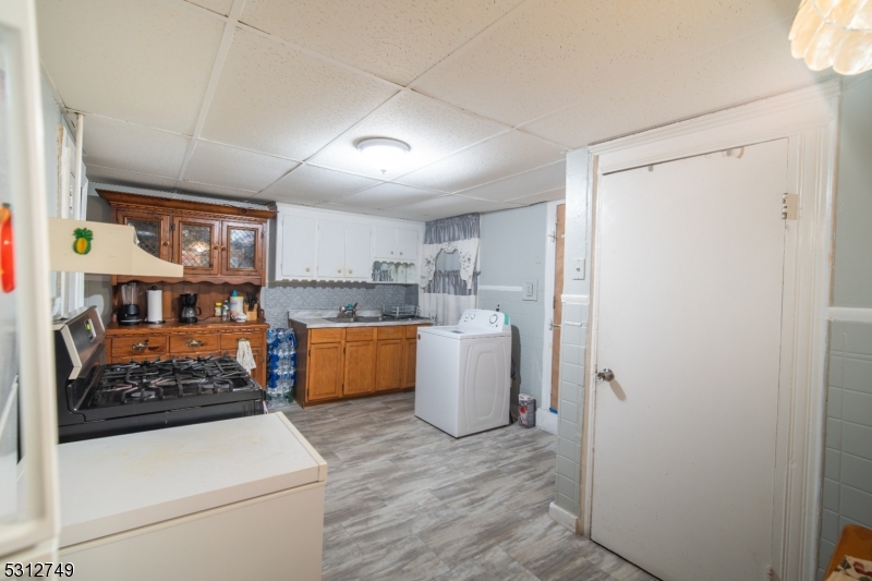 124 Stone Street, Unit 2 Newark, NJ 07104 - Photo 6 of 27 a kitchen with a refrigerator and a sink
